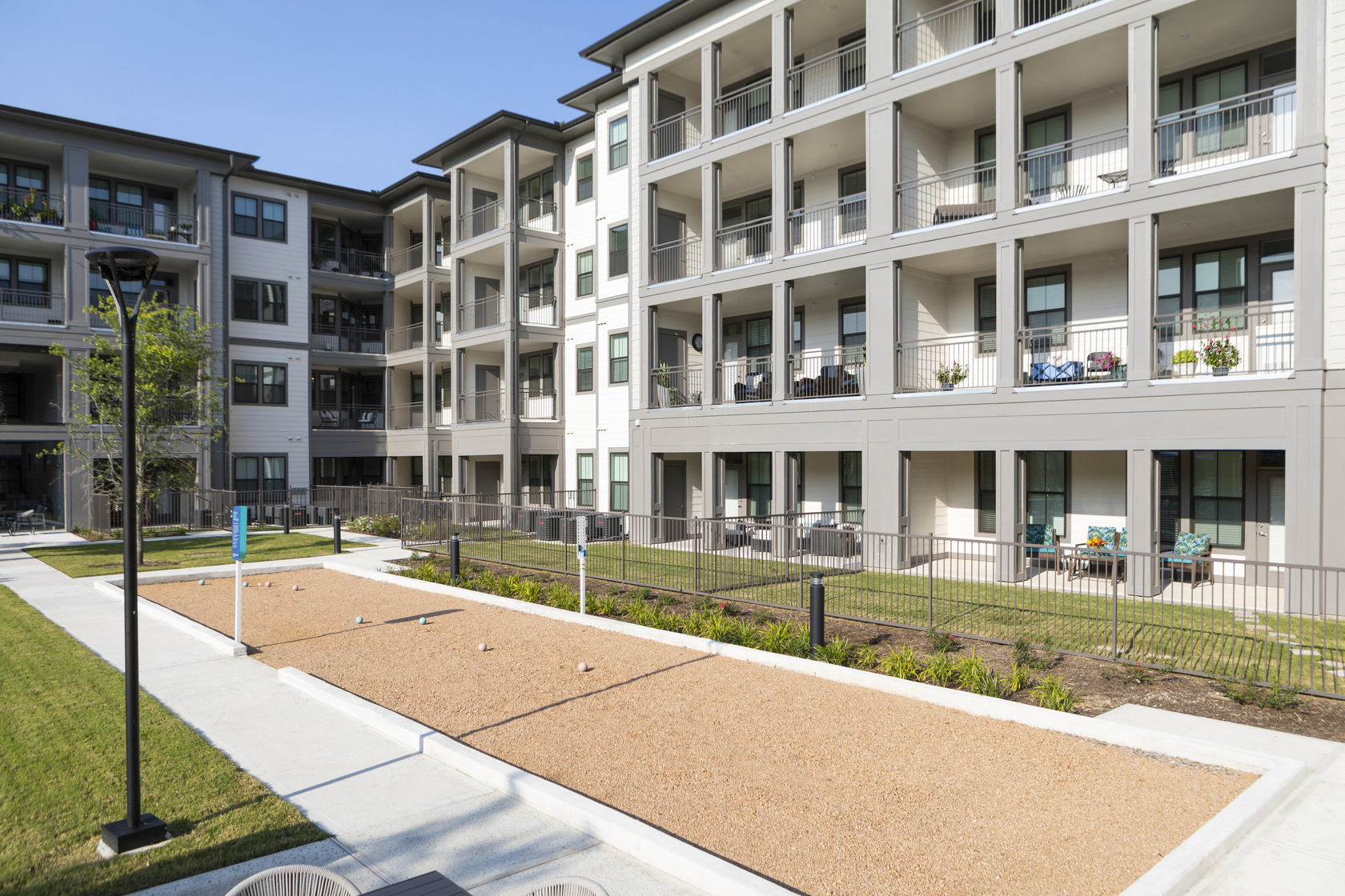 a bocce ball court and lawn at a senior apartment community
